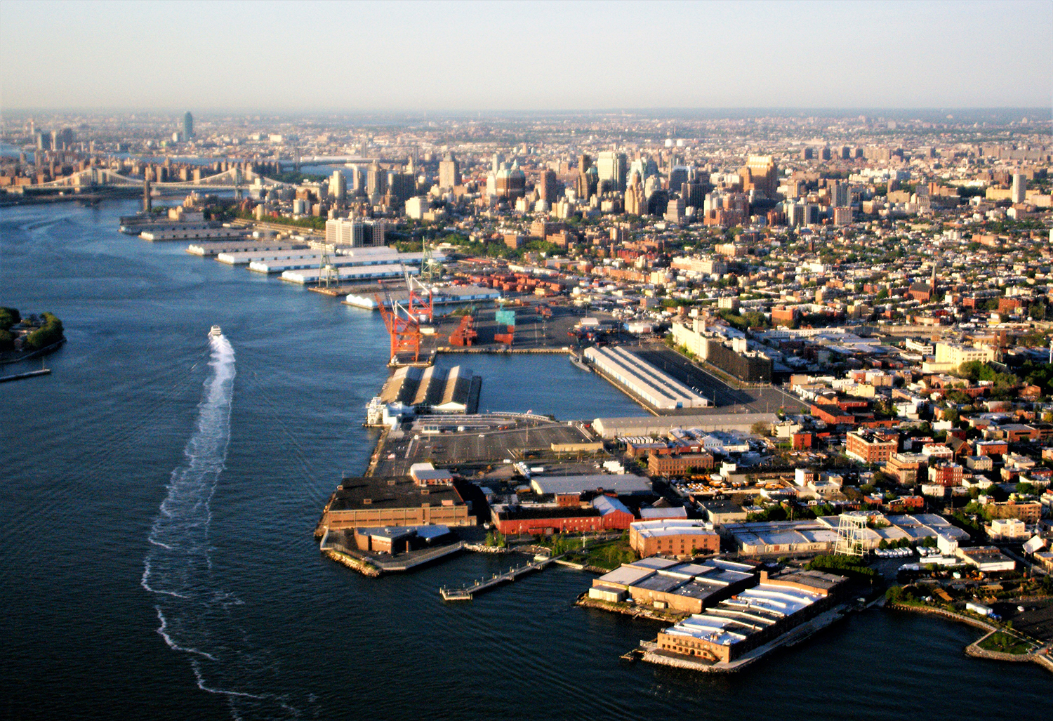 Aerial view of Brooklyn Marine Terminal showing a waterfront with Red Hook in foreground and East River in background.